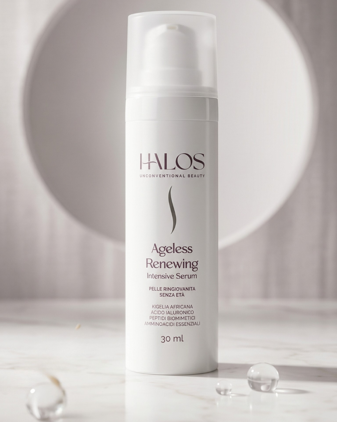 Flacone airless di Ageless Renewing Intensive Serum Halos da 30 ml su marmo chiaro