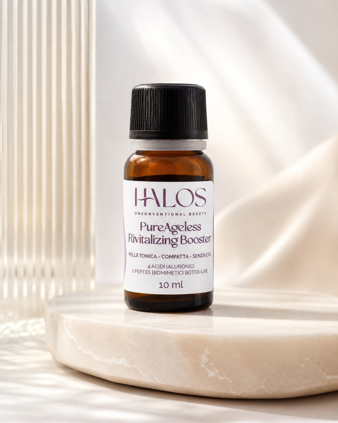 Flacone di PureAgeless Revitalizing Booster Halos da 10 ml su una base in pietra